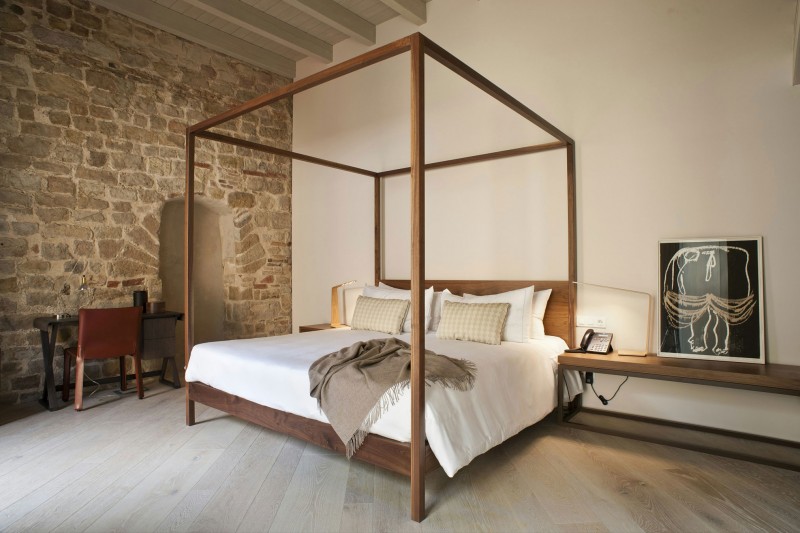 Hotel style bedroom with exposed bricks walls