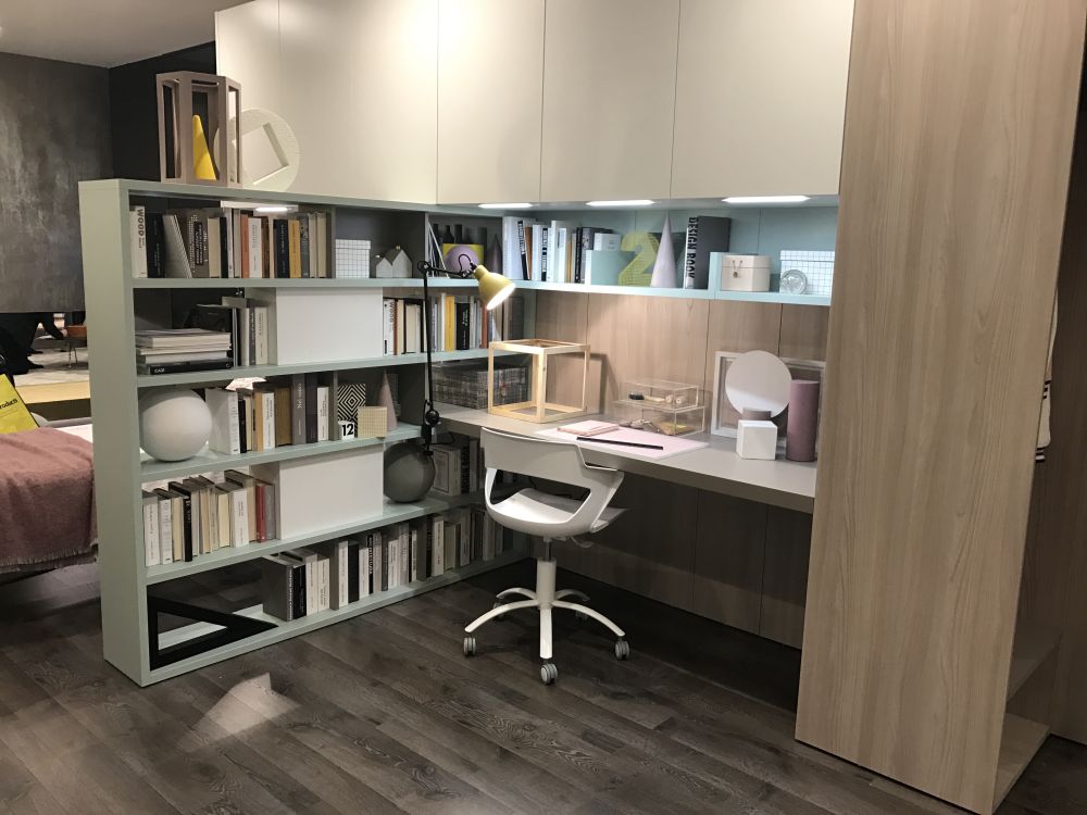 You can add storage to a desk in the form of a bookcase which can double as a space divider