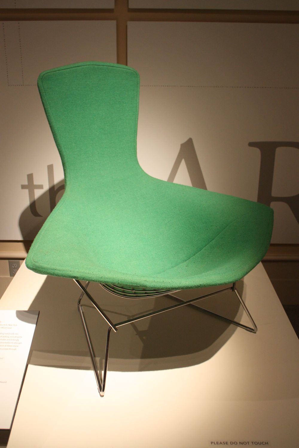 Iconic green chair with hairpin legs