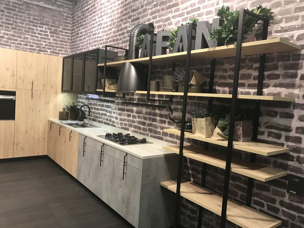 The wood and metal combo suits these kitchen shelves well, especially with the exposed brick backdrop