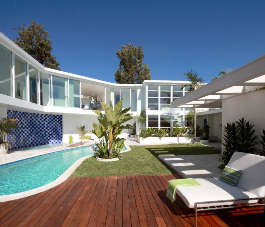 Inspiration for a mid sized contemporary backyard custom shaped pool house