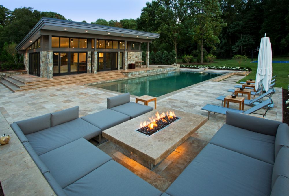 Inspiration for a mid sized modern backyard stone and rectangular natural pool