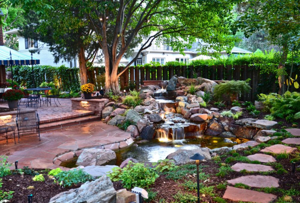 Inspiration for a traditional backyard stone waterfall in Denver