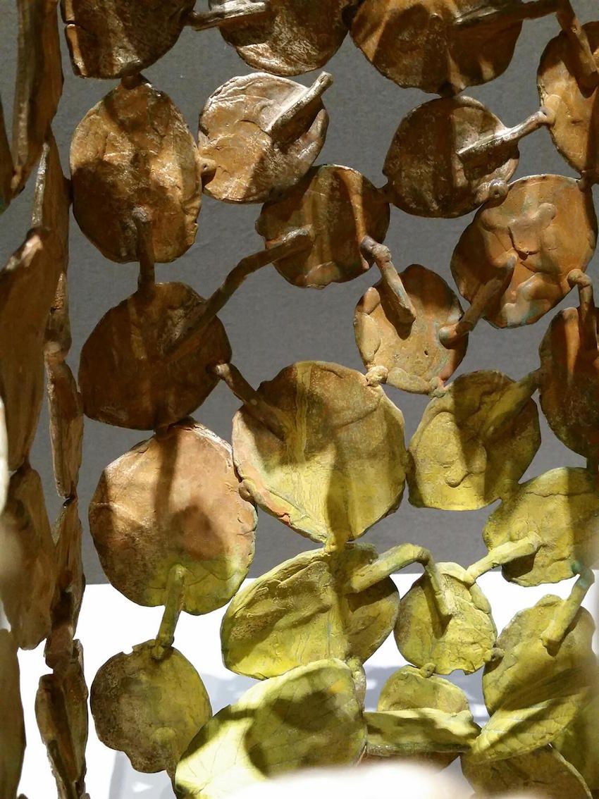 Each piece has a different color gradation, and with the varying light from different angles, reminds the viewer of dappled sunlight on the leaves.