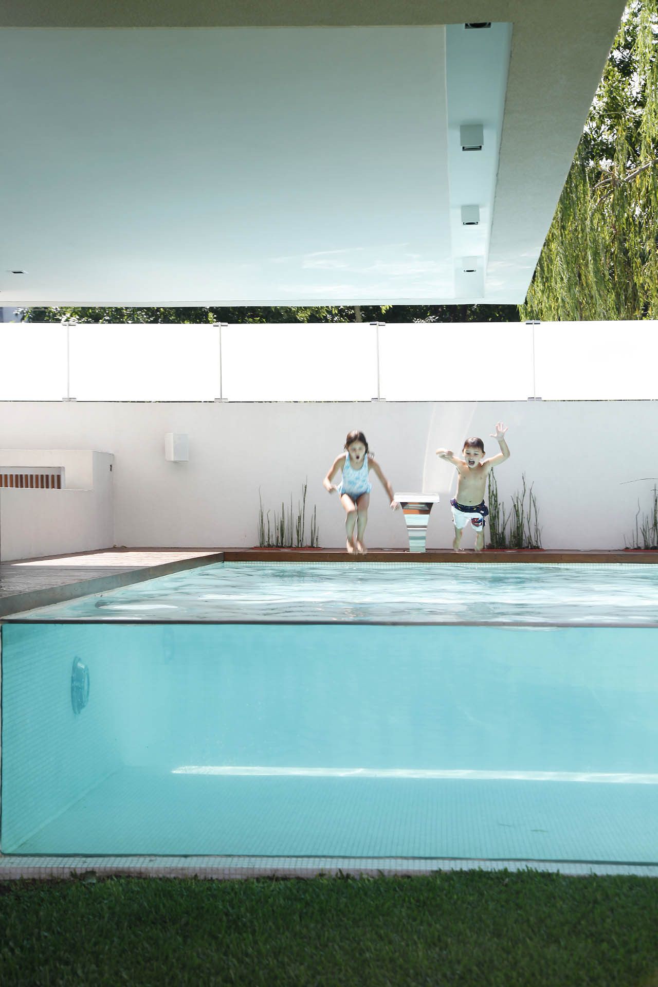 Kids jumping in the swimming pool