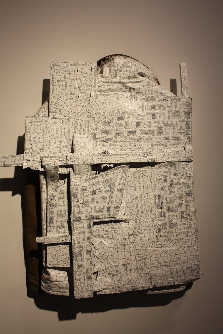 The piece comprises a jacket, wood, acrylic and ink