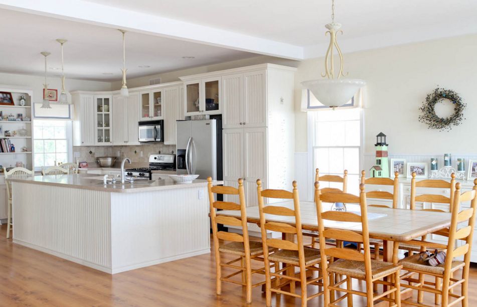 Kitchen highlighted by wood laminate floor