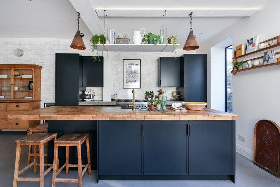 Kitchen with an industrial flair featuring a wood countertop