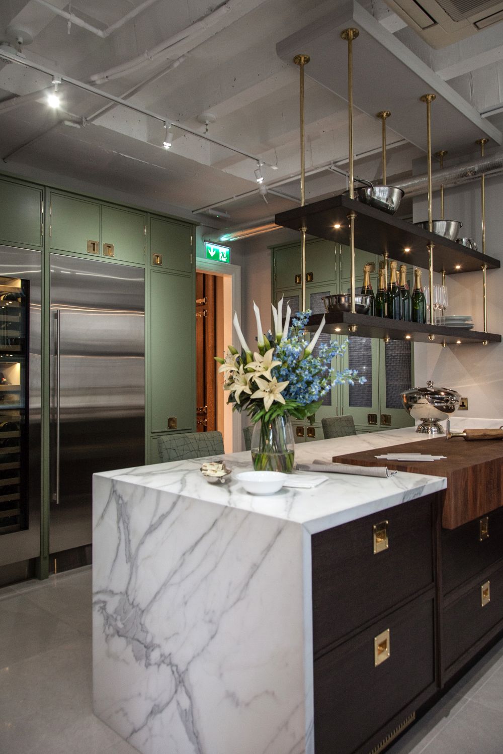 Kitchen with brass accents and waterfall marble