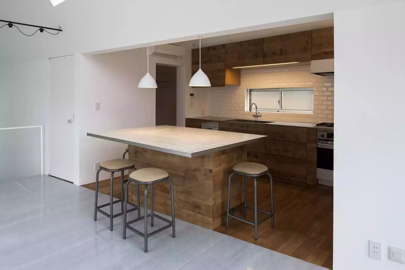 Industrial style simple kitchen with subway tiles in garage