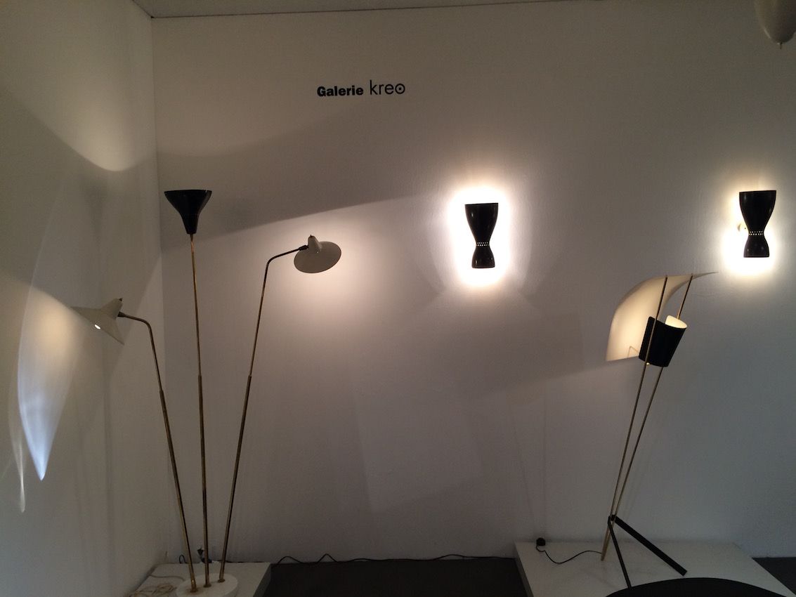 A variety of floor lamps illuminate one section of the display area.