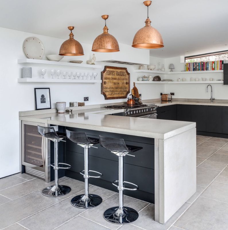 L shaped kitchen with wine fridge and copper pendants