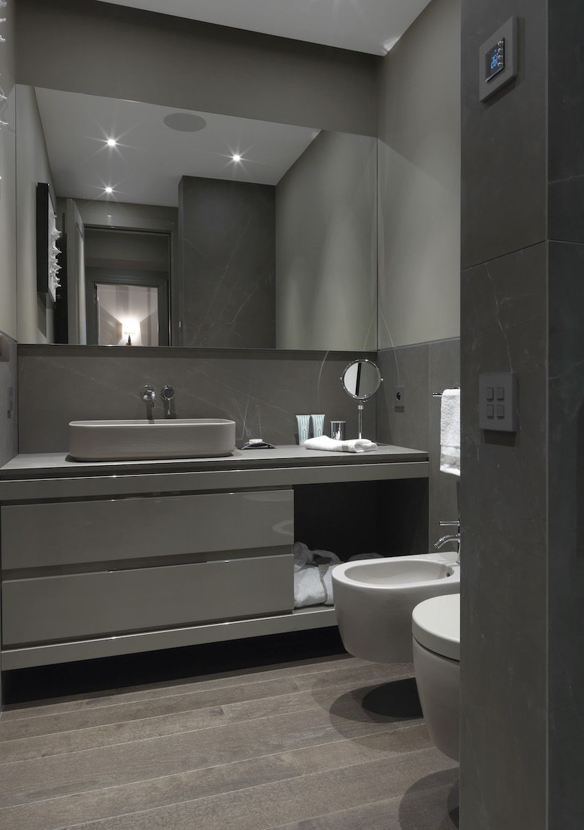 The sleek second bathroom has one basin set atop the vanity.