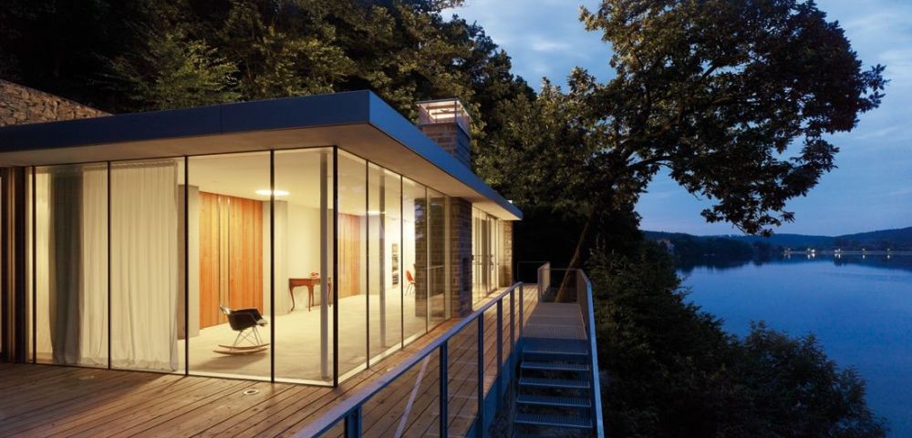 Lake House Prefab with green roof and waterfront by LHVH Architekten glass walls