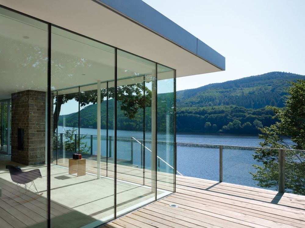 Lake House Prefab with green roof and waterfront by LHVH Architekten view