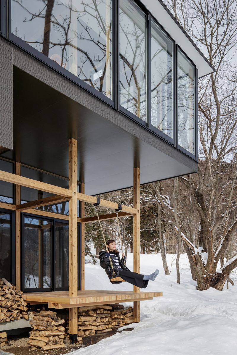 Lakeside cottage with a fresh design perspective swing