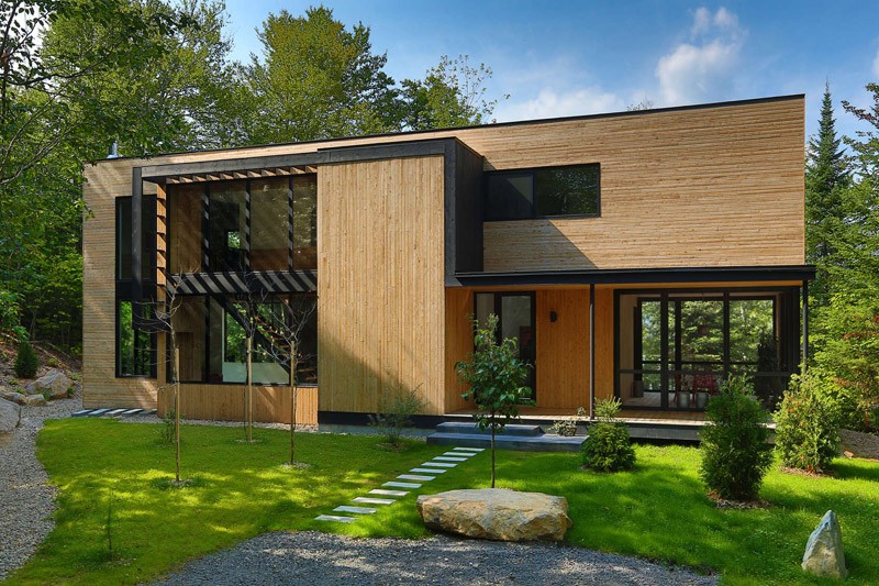 Lakeside retreat surrounded by forest front view