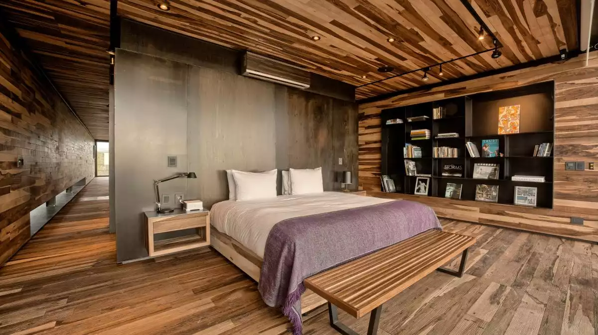 Large bedroom with stainless steel feature wall and built in shelves