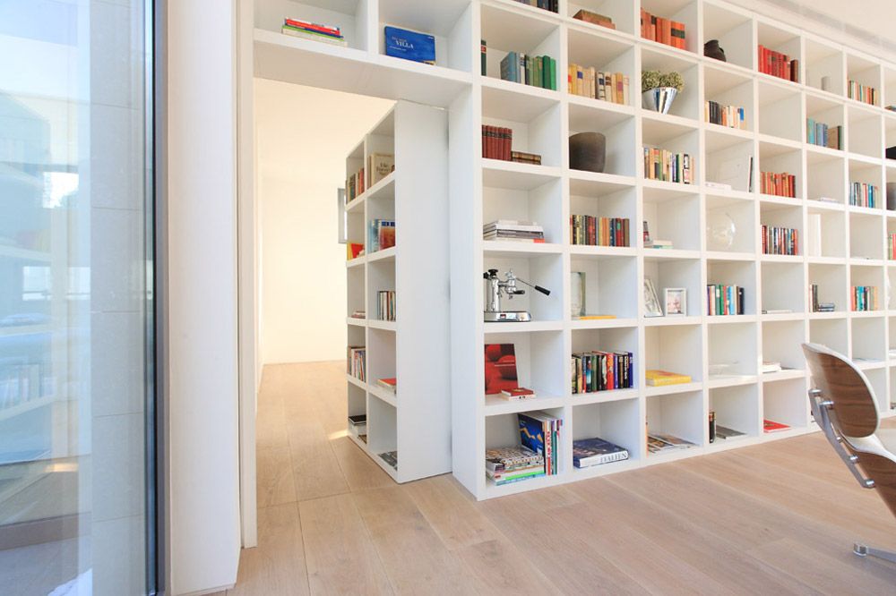 Large white modular bookcase with hidden door