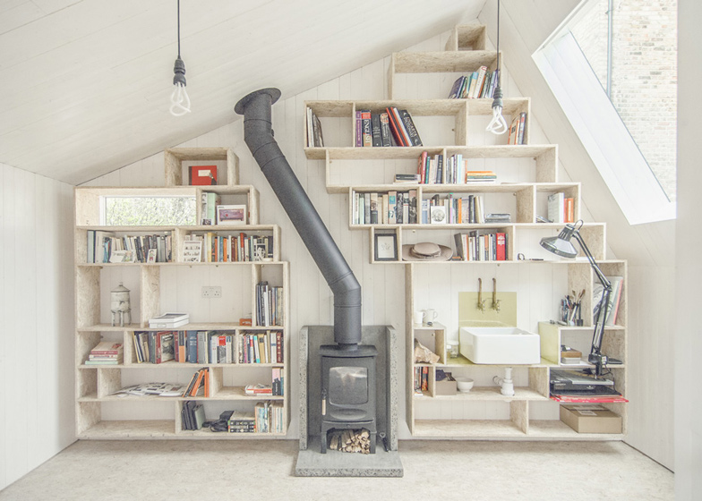 Light writing shed shelves and burning wood fireplace