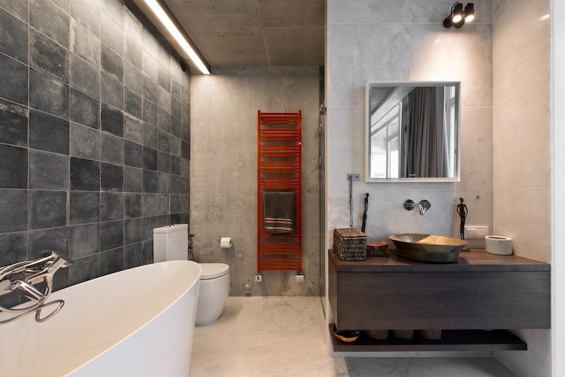 The bathroom is similarly simple and it too has warm wood accents and touches of color