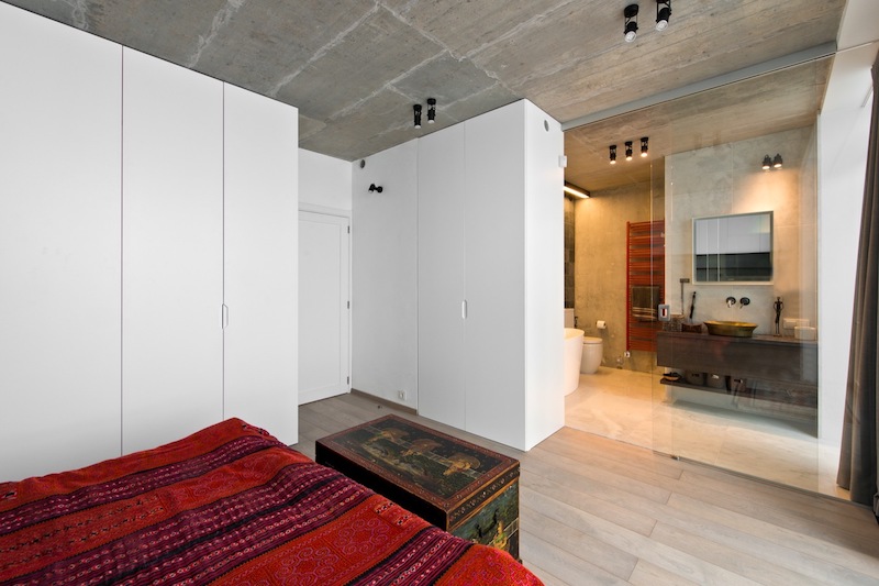 The master bedroom is separated from its en-suite by sliding glass doors