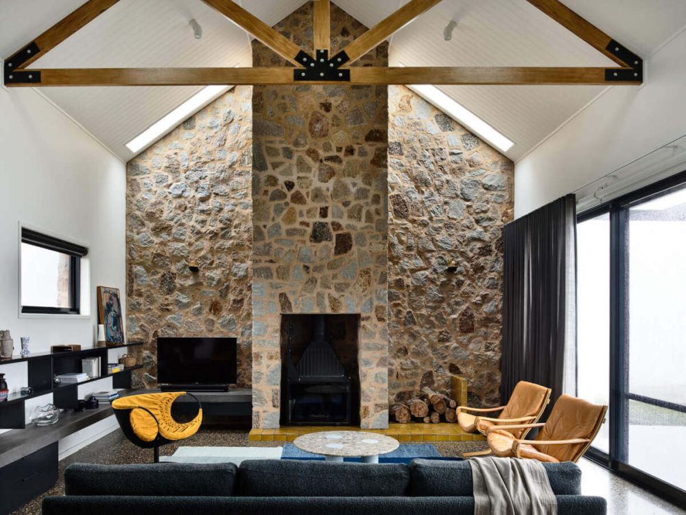 Living Room with stone wall and fireplace
