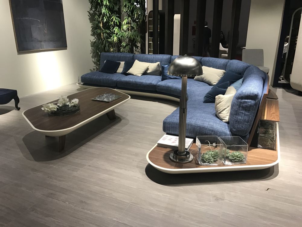 Living room featuring a large curved sofa with shelf