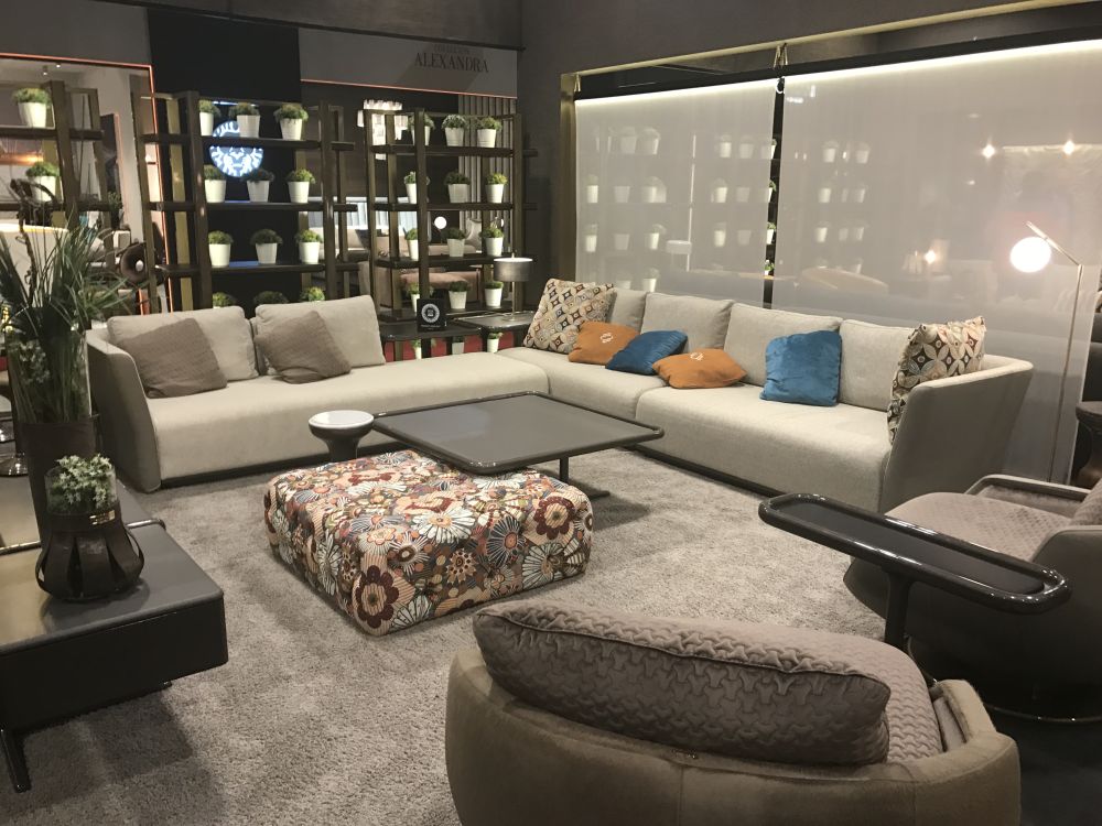 Living room featuring an upholstered ottoman and coffee table