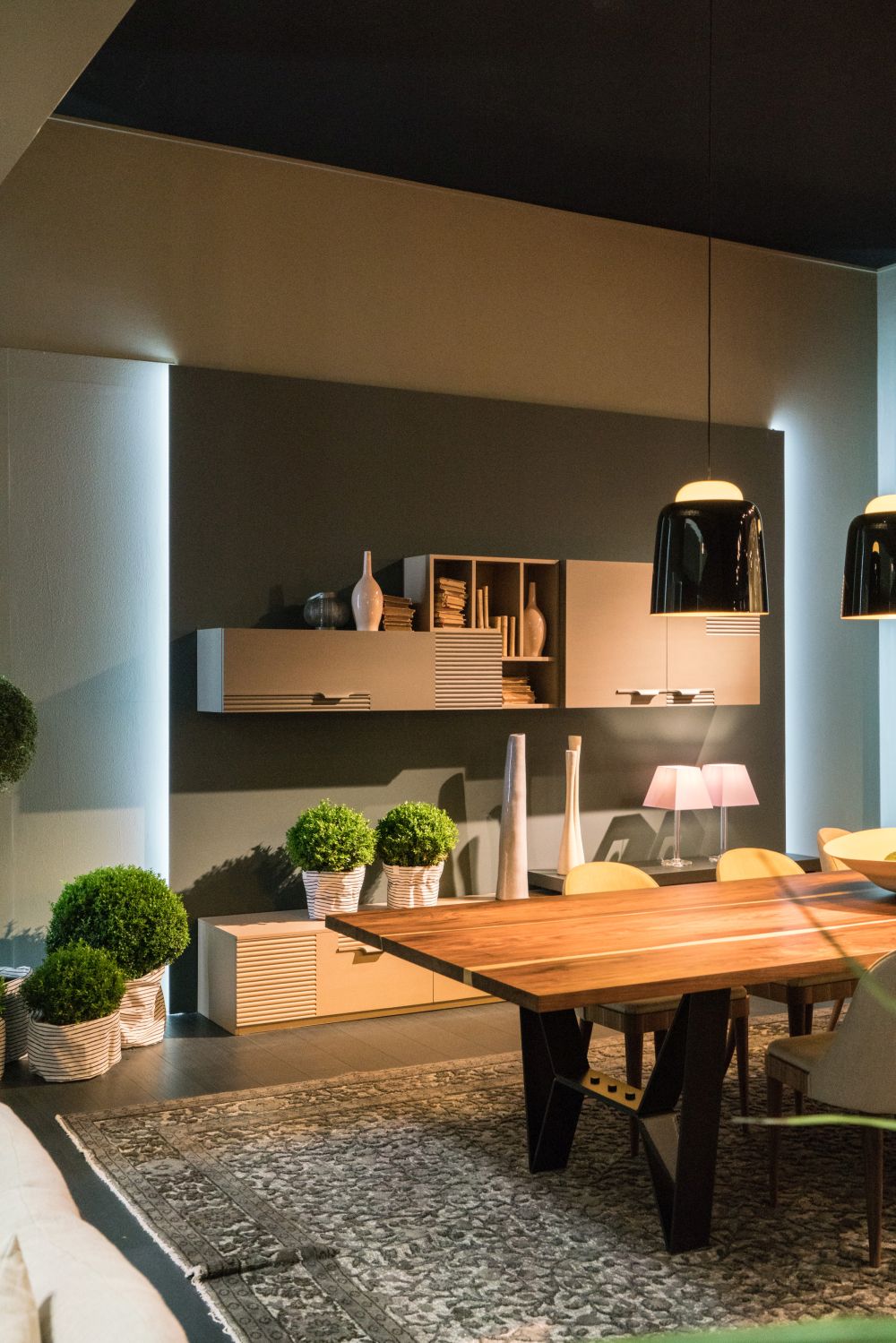 Living room with a large dining table and modern pendant lights