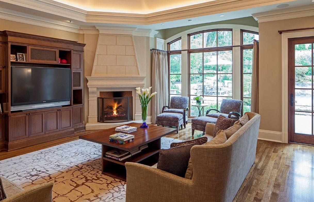 Living room with beautiful floor finish and corner fireplace