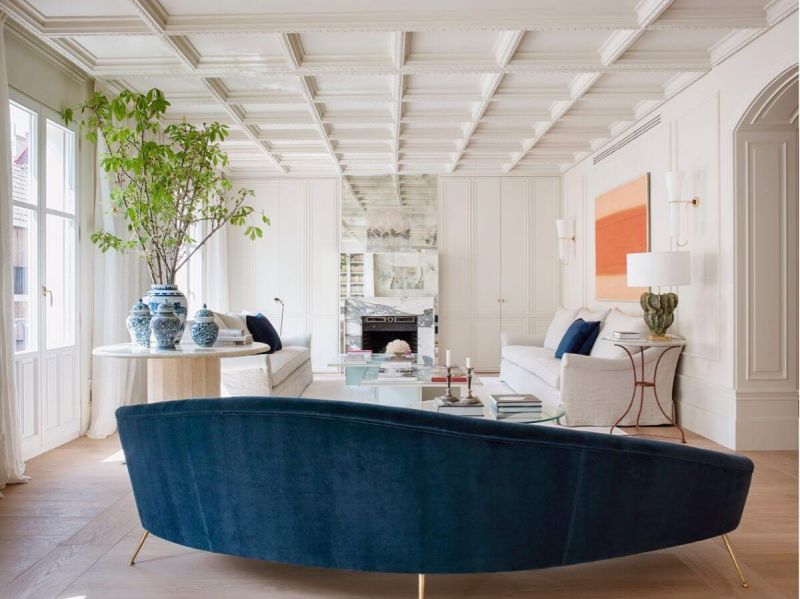 Living room with blue sofa and white fireplace