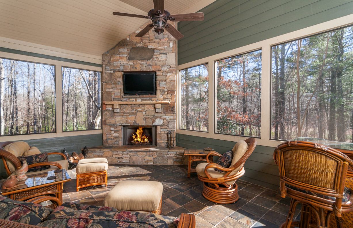 Living room with forest view and corner fireplace