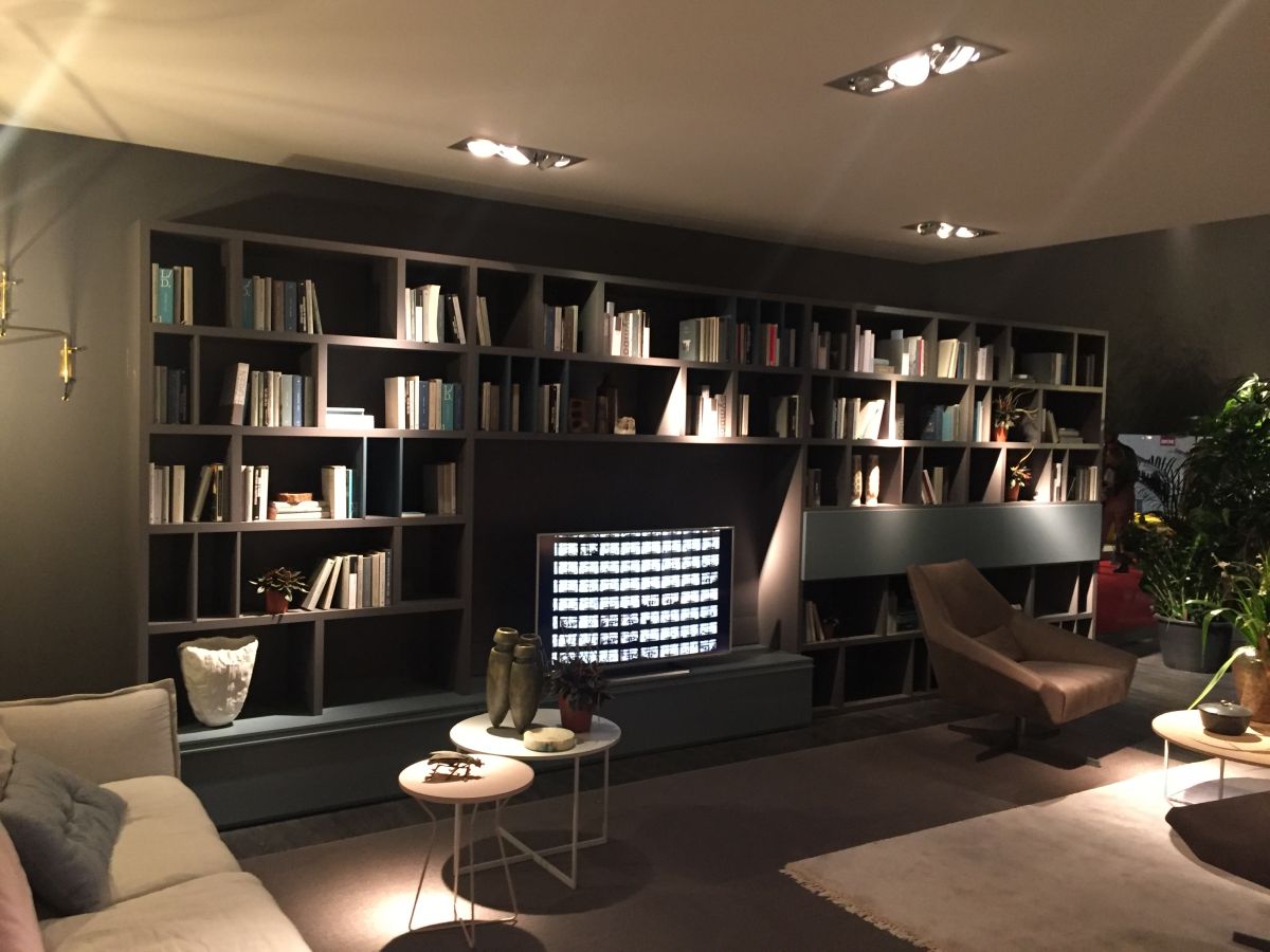 Living room with large wall unit used like library tv built in