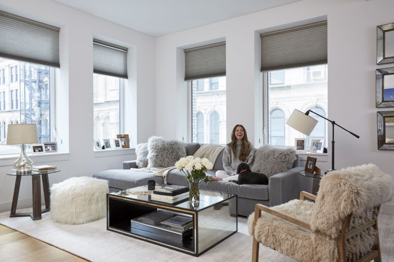 Living room with mirrored coffee table and window shades