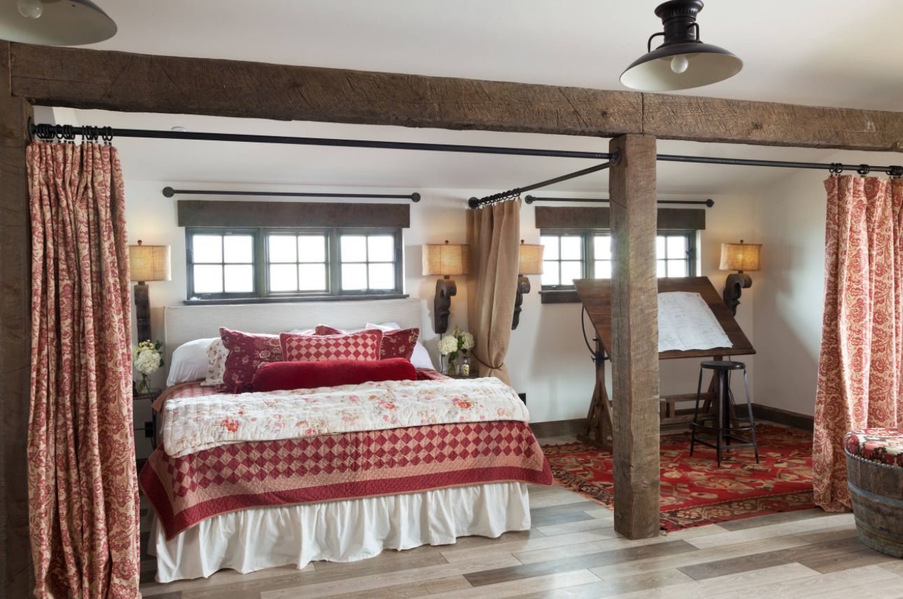 Low ceiling room and curtains room divider exposed beams