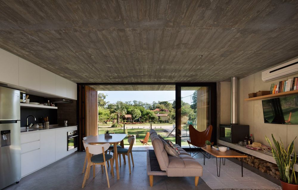 The interior is bright, open and surprisingly cozy for a house with concrete all around it
