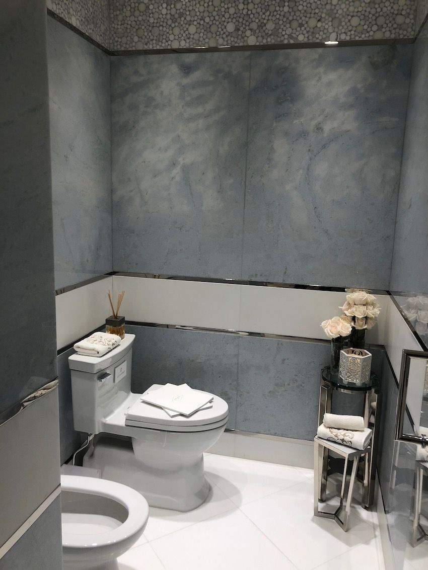 The bedroom's blueish-gray accents are repeated in the bath with a more contemporary flair.