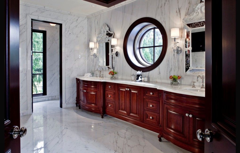 Master bathroom with brown cherry furniture and marble floor