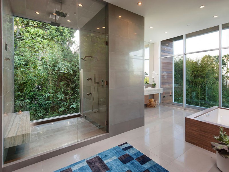 Master bathroom with walk in shower featuring a large window