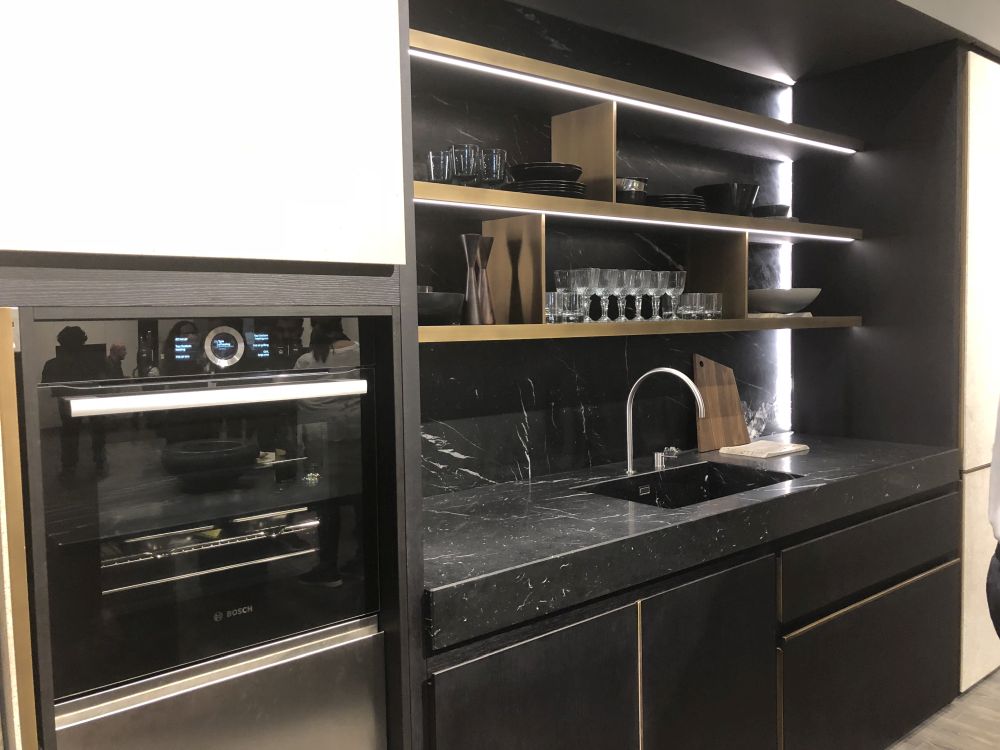 Minimalist black kitchen design with LED light shelves and marble