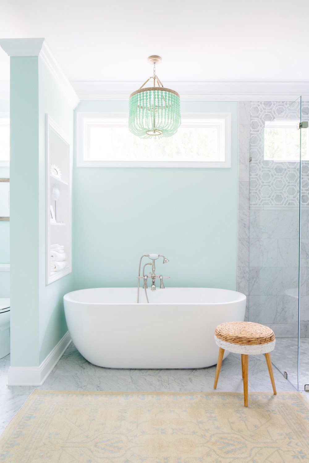 Mint green bathroom with freestanding tub