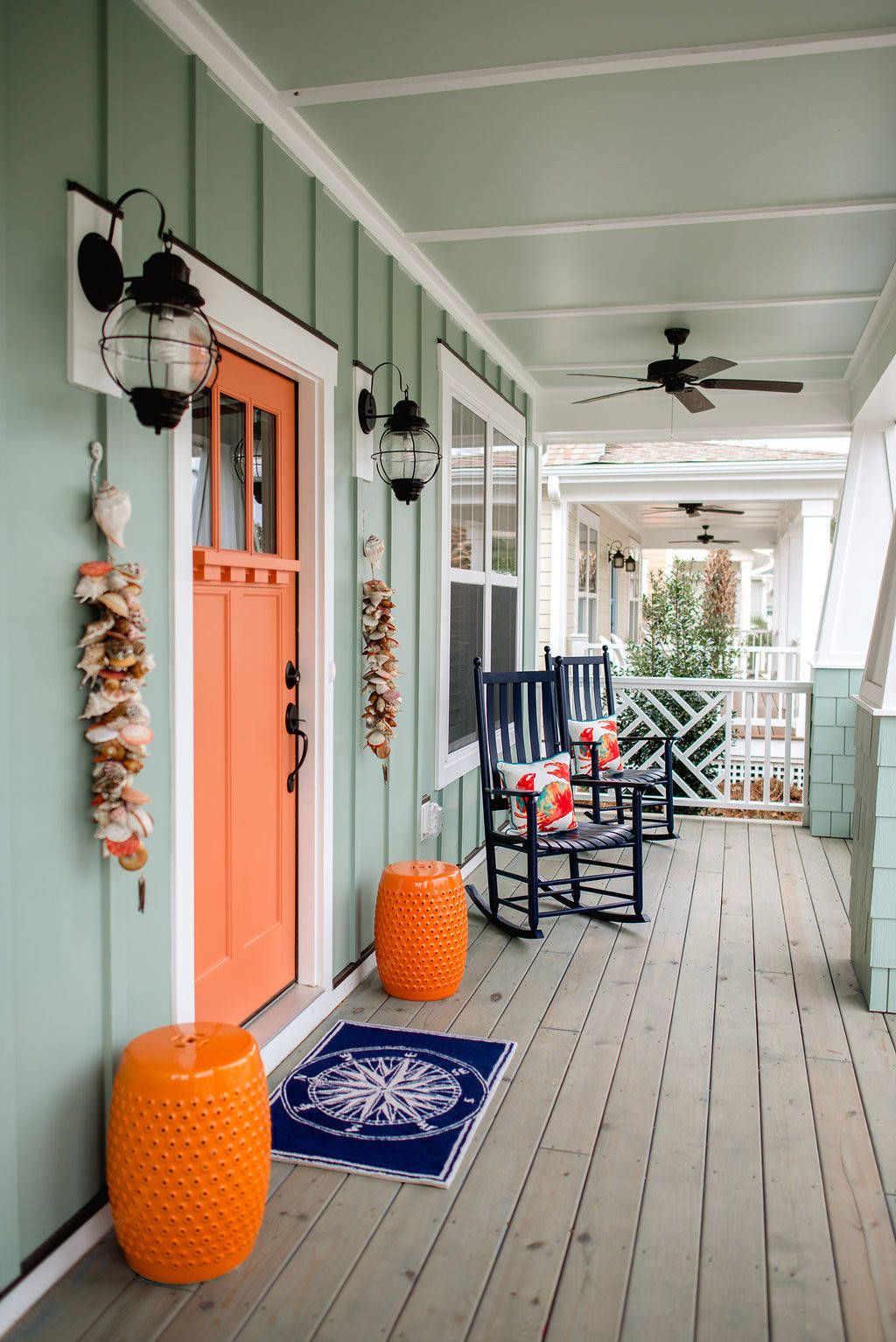 Mint green front porch with orange cermic stools