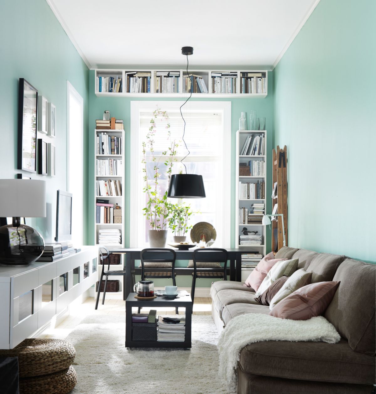 Mint living room design with white bookshelves