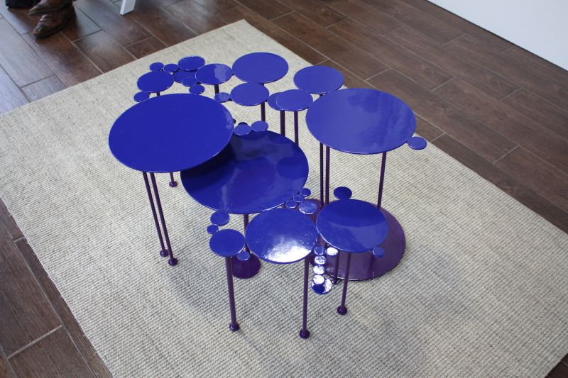 This is a colorful collection of small tables by sculptor Miriam Ancis. The versatile art pieces can be used singly or grouped together to serve as a coffee table. Ancis started making these small pieces for herself, but found that so many friends were requesting them that she began production.