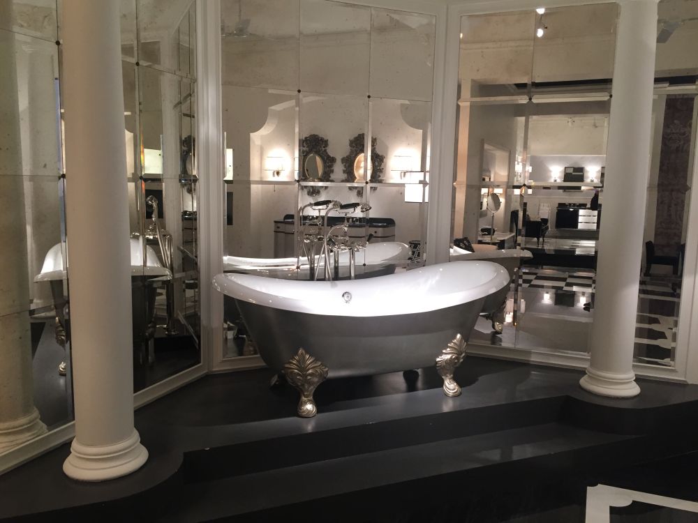 Mirror wall and a clawfoot tub with silver legs to create a luxury bathroom