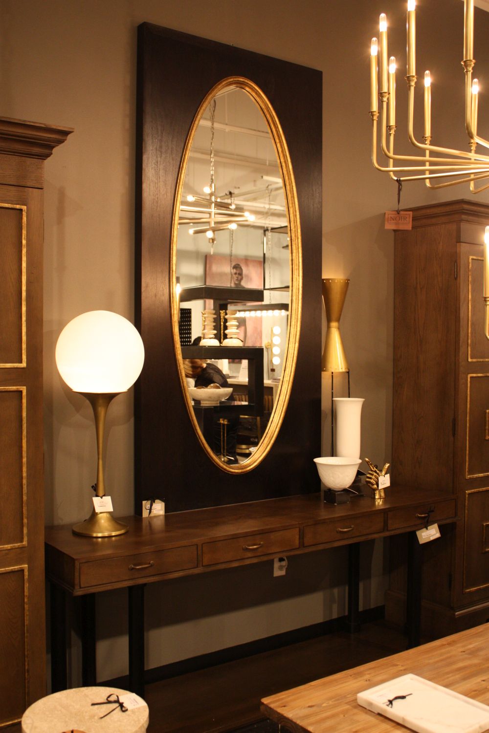 Mirror with black frame and gold accents