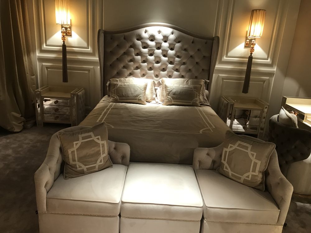 Mirrored table nights and upholsted bed headboard