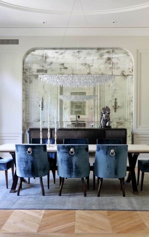 A metallic torso statue is an elegant accessory for this dining room.