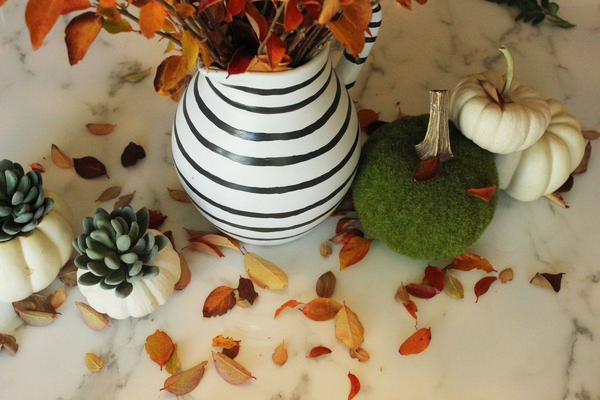 Modern Thanksgiving Table Setting-branches were being put into the pitcher